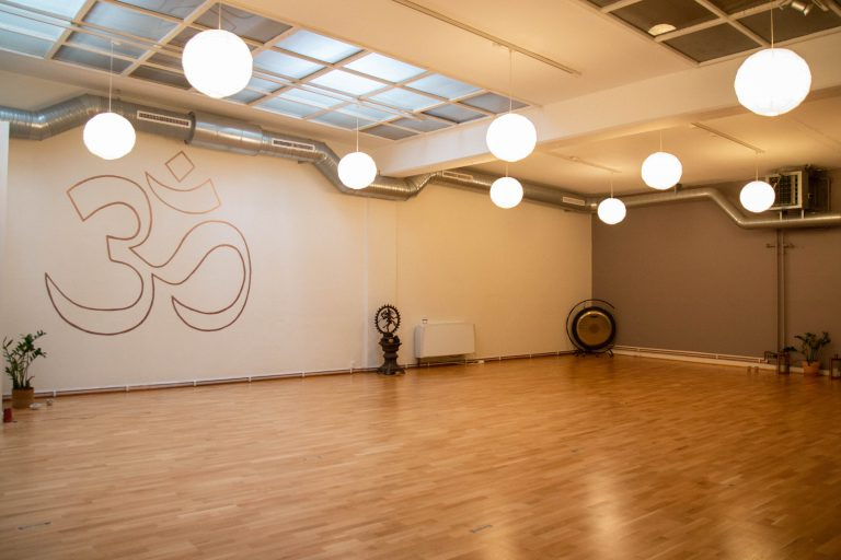 Yoga Kenda Studio for rent in Malmö A different angle of the empty yoga studio showcasing the wide wooden floorboards and rows of glowing round lights