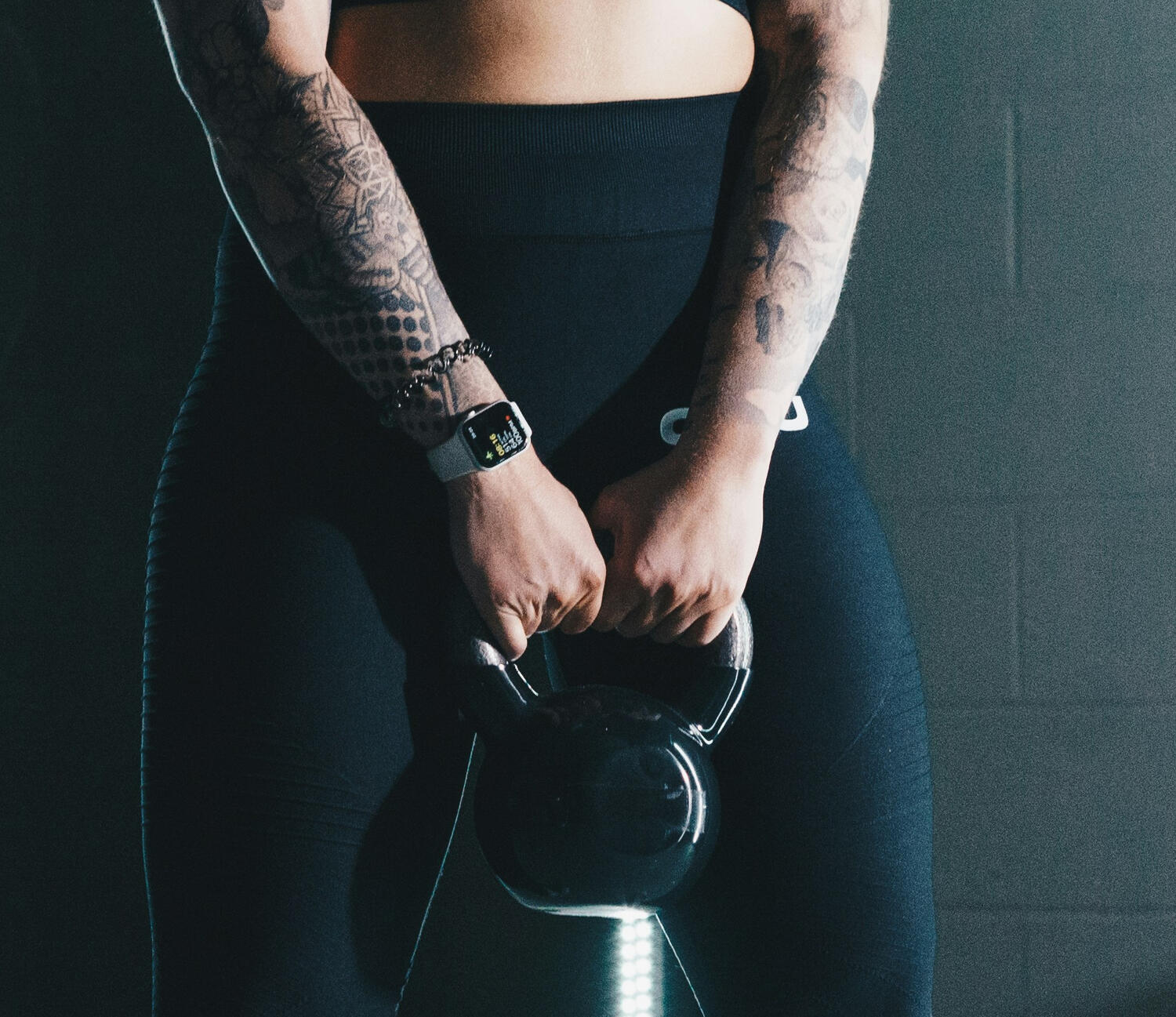 Yoga Kendra Malmö Strength & Mobility Yoga Instructor squatting and holding a weight